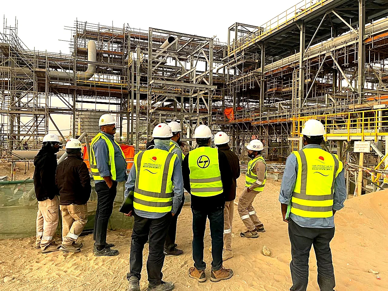 Engineering team reviewing structural steel progress